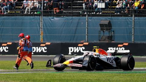 Marshal runs on the track in front of Liam Lawson's Racing Bull during the Mexico City Grand Prix