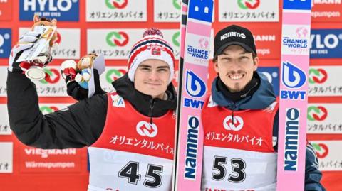 Marius Lindvik and Johann Andre Forfang on the podium after winning a Ski Jumping World Cup event in February.