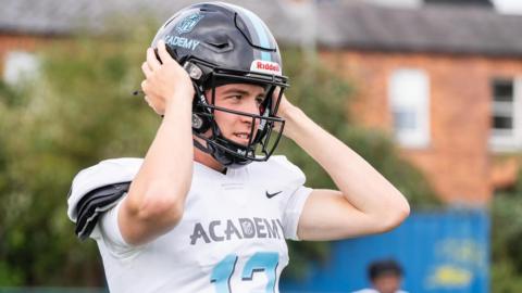 Sam Fenton puts on his helmet