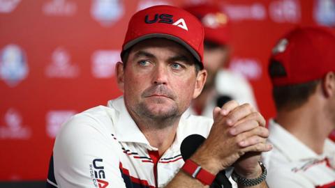 Keegan Bradley with his hands interlinked, staring into the distance