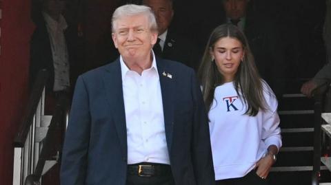 US President Donald Trump, along with his granddaughter Kai Madison Trump, attends the 2025 Ryder Cup
