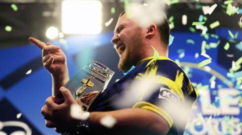 Luke Littler celebrates winning the World Grand Prix final against Luke Humphries