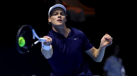 Jannik Sinner plays a forehand