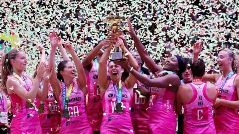 London Pulse players celebrate with the Netball Super League trophy