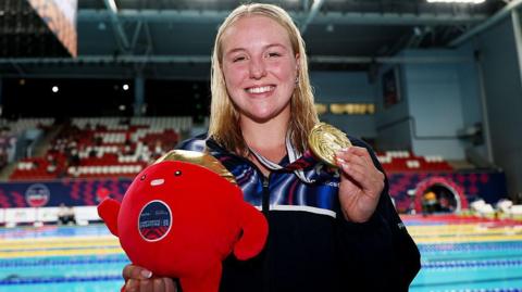 Faye Rogers holding her gold medal