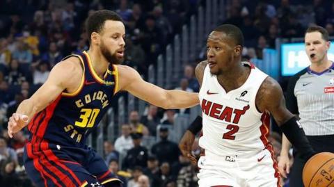 Terry Rozier of the Miami Heat dribbling the ball while being guarded by Stephen Curry of the Golden State Warriors in January 2025