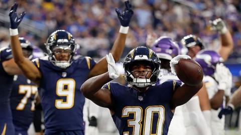 Kimani Vidal celebrates a touchdown for the Los Angeles Chargers against the Minnesota Vikings