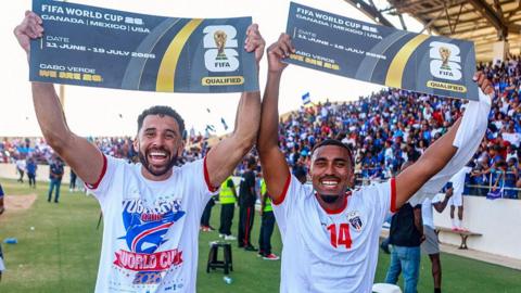 Football players celebrate reaching the World Cup