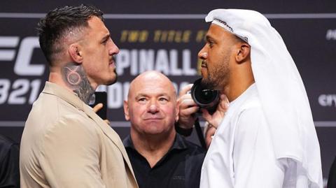 Tom Aspinall faces off with Ciryl Gane at a news conference