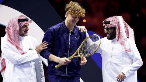 Jannik Sinner with Yasir Al-Rumayyan and Turki Al-Sheikh after winning the Six Kings Slam