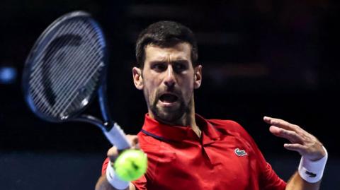 Novak Djokovic hits a return at the Six Kings Slam exhibition event