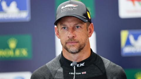 Jenson Button speaking at a press conference