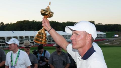 Luke Donald lifts the Ryder Cup towards the European fans